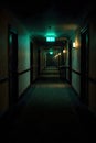 Dark Empty Hotel Corridor With Emergency Exit Sign Creating Suspense And Isolation Mood Royalty Free Stock Photo