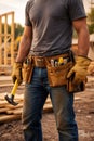 Construction Worker Wearing Tool Belt And Holding Hammer At Building Site Royalty Free Stock Photo