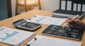 AI generated business financial analysis workspace with tablet charts, calculator and documents on desk Royalty Free Stock Photo