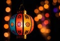 a colorful lantern hanging from a tree with colorful bokeh on dark background Royalty Free Stock Photo