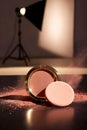 Golden Blush Compact With Powder Burst In Dramatic Studio Lighting Environment Royalty Free Stock Photo