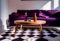 Dark purple sofa with a blanket beside a small table Royalty Free Stock Photo