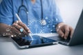 AI generated digital healthcare workspace showing medical professional using tablet and laptop with patient data interface Royalty Free Stock Photo