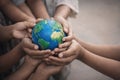 AI generated diverse children hands holding a small vibrant globe symbolizing global unity cooperation responsibility future hope Royalty Free Stock Photo