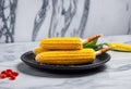 elote grilled mexican corn on the cob on a black plate