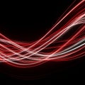 AI generated flowing red and white light streaks on a dark background representing high speed data motion energy and modern Royalty Free Stock Photo