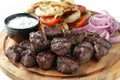 Grilled meat platter with onions and tomatoes, vibrant and delicious, food photography