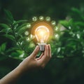 AI Generated Hand Holding Glowing Lightbulb Surrounded by Ecological Symbols Royalty Free Stock Photo