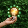 AI Generated Hand Holding Glowing Lightbulb Surrounded by Ecological Symbols Royalty Free Stock Photo