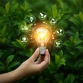 AI Generated Hand Holding Glowing Lightbulb Surrounded by Ecological Symbols Royalty Free Stock Photo