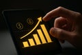 AI generated hand interacting with a digital banking growth chart featuring yellow and black icons representing financial data. Royalty Free Stock Photo