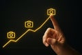 AI generated hand interacting with a yellow digital growth chart with camera icons. Perfect for startup, innovation, and tech- Royalty Free Stock Photo