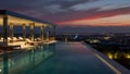 AI generated The spectacular infinity pool and luxurious terrace of a five-star hotel are overlooking a sprawling illuminated city Royalty Free Stock Photo