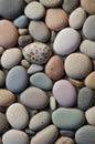 A highresolution image showcasing a serene background of smooth, rounded pebbles in soft, pastel hues, embodying a