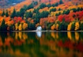 a house sits on a lake surrounded by trees Royalty Free Stock Photo