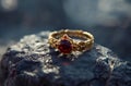 AI-generated illustration of a beautiful ring with a red stone elegantly placed on a rock surface Royalty Free Stock Photo