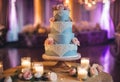 a wedding cake on a table with candles on it and pink roses Royalty Free Stock Photo