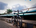 a bike leaning up against a rail at a bridge over a river