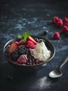 AI-generated illustration of a bowl of berries and ice cream on a dark surface Royalty Free Stock Photo