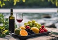 a bowl of fruit sitting next to a bottle of wine Royalty Free Stock Photo