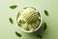 AI generated illustration of a bowl of green mint sorbet on a green surface with leaves