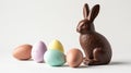 a chocolate bunny sits next to eggs and other candies Royalty Free Stock Photo