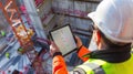AI-generated illustration of a civil engineer in a hard hat using a tablet Royalty Free Stock Photo