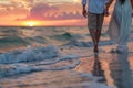 a couple holding hands and walking on the beach at sunset, with waves crashing in the background Royalty Free Stock Photo