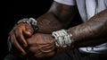 AI generated illustration of a close-up of a man with tattoos and bracelets adorning his arms Royalty Free Stock Photo