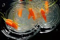 a bunch of carrots are shown in clear water and bubbles