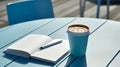 AI generated illustration of a cup of coffee on a wooden blue table with a blank notebook and a pen Royalty Free Stock Photo