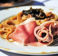 AI generated illustration of a delicious-looking pasta with ham slices on a white plate Royalty Free Stock Photo