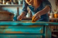 AI generated illustration of a female removing old paint from a wooden table Royalty Free Stock Photo