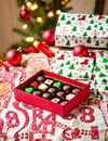 AI generated illustration of A festive holiday scene featuring boxes of Christmas chocolates Royalty Free Stock Photo