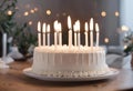 AI generated illustration of a freshly baked white birthday cake with lit candles Royalty Free Stock Photo