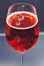 AI generated illustration of a full glass of red wine on a gray tabletop Royalty Free Stock Photo
