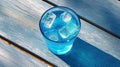 AI generated illustration of a glass of blue cocktail with ice cubes on a wooden table Royalty Free Stock Photo