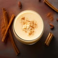 AI generated illustration of a glass filled with creamy, milky coffee, cinnamon sticks next to it