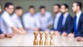 AI generated illustration of a group of people discussing a strategy with chess figures on the table Royalty Free Stock Photo
