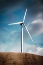 AI generated illustration of an industrial wind turbine in a vast, sandy desert landscape Royalty Free Stock Photo