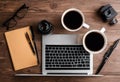 AI generated illustration of a laptop computer on a wooden desk with two steaming cups of coffee Royalty Free Stock Photo