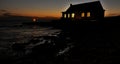 AI generated illustration of the light illuminating oceanfront house Royalty Free Stock Photo