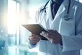 male doctor holding a clipboard with both hands, and his face closed