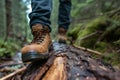 a man in work boots standing on a log in the forest