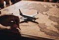 a small model airplane is sitting on a map of the world