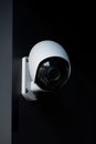 AI-generated illustration of a modern security camera mounted on a black wall.