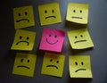 AI generated illustration of multi-colored post-it notes with a variety of sad facial expressions Royalty Free Stock Photo