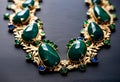 a necklace with large emerald green stones on a black surface