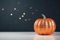 AI generated illustration of an orange glittered pumpkin in front of a gray background