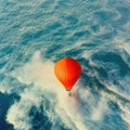 AI generated illustration of an orange hot air balloon flying over a beautiful foamy seascape
